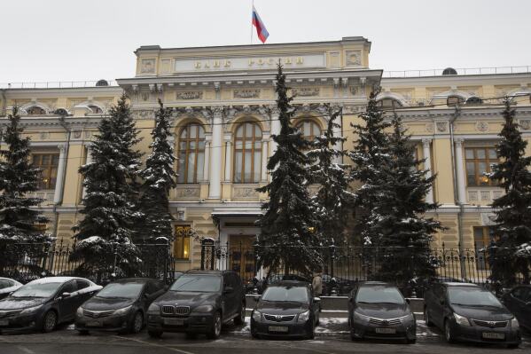 FILE - Cars are parked in front of Russia's Central Bank building in Moscow, Russia, Friday, Jan. 30, 2015. The Central Bank of Russia raised its key lending rate by one percentage point to 13% on Friday, Sept. 15, 2023, a month after imposing an even larger hike, as concerns about inflation persist and the ruble continues to struggle against the dollar. (AP Photo/Alexander Zemlianichenko, File)