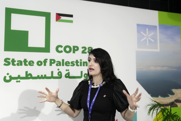 Hadeel Ikhmais, a climate change expert with the Palestinian Authority, speaks to 花椒直播 at the COP28 U.N. Climate Summit, Friday, Dec. 1, 2023, in Dubai, United Arab Emirates. (AP Photo/Joshua A. Bickel)