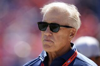 FILE - Denver Broncos consultant John Elway looks on against the Houston Texans during an NFL football game Sunday, Sept. 18, 2022, in Denver. Elway, who had a hand in all three of the Lombardi Trophies glistening in the Denver Broncos' trophy case, no longer has any formal ties to the team he defined for more than four decades. Elway's contract as an outside consultant to George Paton, his hand-picked successor as general manager, expired last month and wasn't renewed. (AP Photo/Jack Dempsey, File)
