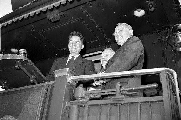 FILE - A group of Ohio democratic leaders greet President Truman when his train stopped briefly at Crestline, Ohio, June 4, 1948. Standing with Truman is Former Gov. Frank J. Lausche, right, and Albert A. Horstman, former democratic chairman. (APPhoto, File)