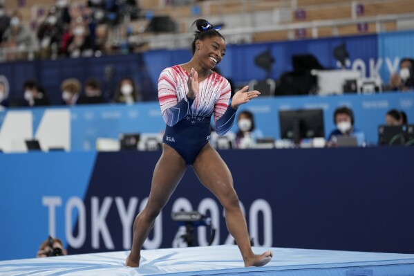 FILE - Simone Biles reacts after competing on the balance beam at the Tokyo Olympics, Tuesday, Aug. 3, 2021. USA Gymnastics announced Wednesday, June 28, 2023, that Biles, the 2016 Olympic champion, will be part of the field at the U.S. Classic outside of Chicago on Aug. 5. The meet will be Biles first since the 2020 Olympics. (AP Photo/Ashley Landis, File)