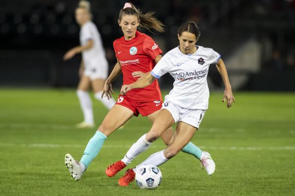 Kansas City midfielder Addie McCain (28) attempts to collect the ball from Houston Dash midfielder Shea Groom (6) during an NWSL soccer game, Wednesday, Oct. 13, 2021 in Kansas City, Kan. (Nick Smith/The Kansas City Star via AP)