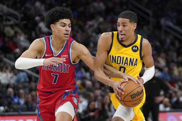 Detroit Pistons guard Killian Hayes (7) strips the ball from Indiana Pacers guard Tyrese Haliburton (0) in the second half of an NBA basketball game in Detroit, Friday, March 4, 2022. (AP Photo/Paul Sancya)