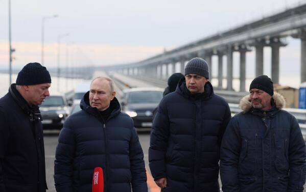 Russian President Vladimir Putin, second left, listens to Deputy Prime Minister Marat Khusnullin, left, as he visits the Crimean Bridge connecting Russian mainland and the Crimean Peninsula over the Kerch Strait on Monday, Dec. 5, 2022. The bridge was damaged by a truck bomb in October in an attack that Russia blamed on Ukraine. (Mikhail Metzel, Sputnik, Kremlin Pool Photo via AP, File)