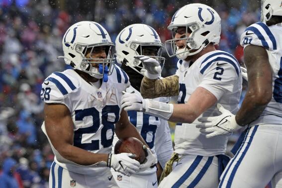 Indianapolis Colts running back Jonathan Taylor (28) celebrates with Carson Wentz (2) after scoring during the second half of an NFL football game against the Buffalo Bills in Orchard Park, N.Y., Sunday, Nov. 21, 2021. (AP Photo/Adrian Kraus)