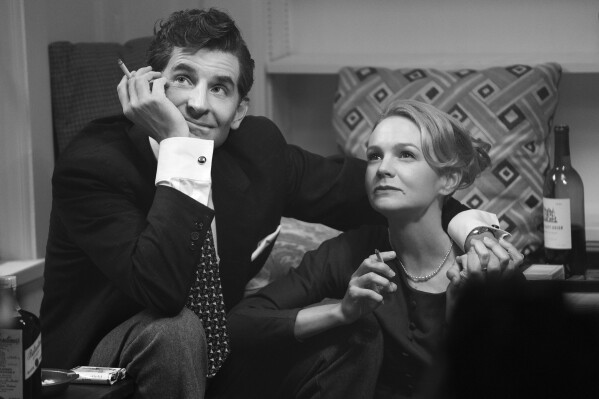 This image released by Netflix shows Carey Mulligan as Felicia Montealegre, right, and Bradley Cooper as Leonard Bernstein in a scene from "Maestro." (Jason McDonald/Netflix via AP)