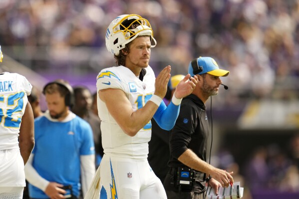 Los Angeles Chargers quarterback Justin Herbert (10) reacts on the sideline during the first half of an NFL football game against the Minnesota Vikings, Sunday, Sept. 24, 2023, in Minneapolis. (AP Photo/Abbie Parr)