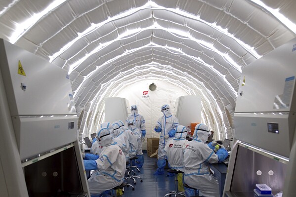 FILE - In this file photo released by China's Xinhua News Agency, staff members work in an inflatable COVID-19 testing lab provided by Chinese biotech company BGI Genomics, a subsidiary of BGI Group, in Beijing, June 23, 2020. Members of Congress are raising alarms about what they see as America's failure to compete with China in biotechnology, with risks to U.S. national security and commercial interests. But as the countries' rivalry expands into the biotech industry, some say that shutting out Chinese companies would only hurt the U.S. (Chen Zhonghao/Xinhua via AP, File)