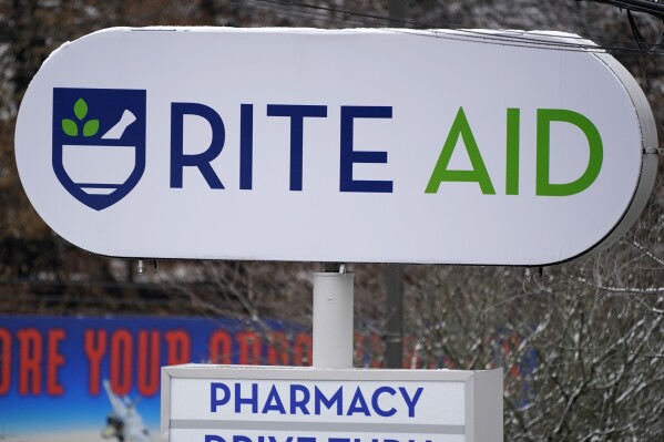 A Rite Aid sign stands in front of one of the drugstore's locations in Pittsburgh on Monday, Jan. 23, 2023. Rite Aid’s plan to close more stores as part of its bankruptcy process raises concern about how that might hurt access to medicine and care. The drugstore chain said late Sunday, Oct. 15, that its voluntary Chapter 11 process will allow it to speed up its plan to close underperforming stores. (AP Photo/Gene J. Puskar)