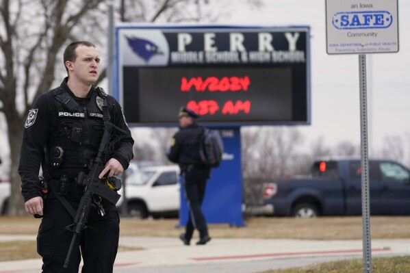 FILE - Police respond to Perry High School in Perry, Iowa, Jan. 4, 2024. Groups pushing tighter gun laws have been building political muscle through multiple elections, boosted by the outcry following mass shootings at schools and other public places, to say nothing of the nation's daily gun violence. Now, gun control advocates and many Democrats see additional openings created by hardline positions of the gun lobby and their most influential champion, former President Donald Trump. (AP Photo/Andrew Harnik, File)