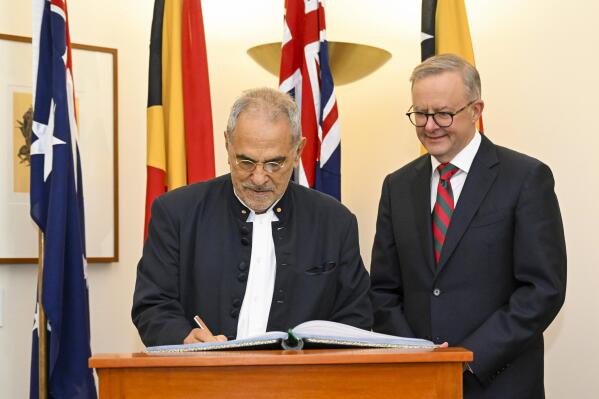 East Timorese President Jose Ramos-Horta, left, signs the visitors book as Australian Prime Minister Anthony Albanese watches ahead of a bilateral meeting at Parliament House in Canberra, Australia, Wednesday, Sept. 7, 2022. Ramos-Horta is on an official visit to Australia. (Lukas Coch/AAP Image via AP)