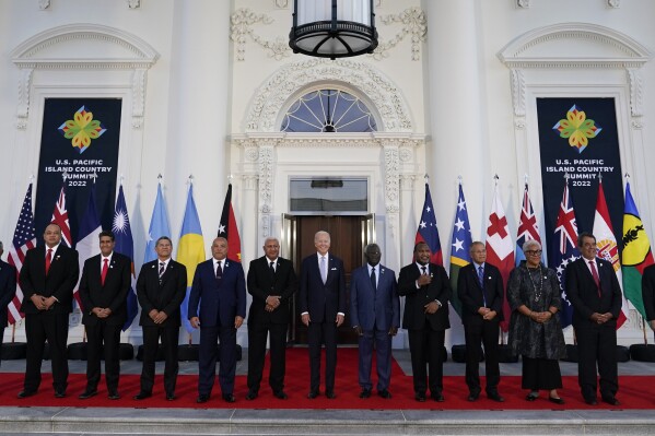 FILE - President Joe Biden, center, poses for a photo with Pacific Island leaders on the North Portico of the White House in Washington, Sept. 29, 2022. From left, New Caledonia President Louis Mapou, Tonga Prime Minister Siaosi Sovaleni, Palau President Surangel Whipps Jr., Tuvalu Prime Minister Kausea Natano, Micronesia President David Panuelo, Fiji Prime Minister Josaia Voreqe Bainimarama, Biden, Solomon Islands Prime Minister Manasseh Sogavare, Papua New Guinea Prime Minister James Marape, Marshall Islands President David Kabua, Samoa Prime Minister Fiame Naomi Mata'afa, French Polynesia President Edouard Fritch and Cook Islands Prime Minister Mark Brown. (AP Photo/Susan Walsh, File)