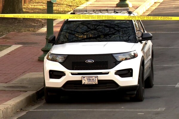 In this image taken from video, police are deployed outside the Israeli Embassy in Washington, Sunday, Feb. 25, 2024, after an active-duty member of the U.S. Air Force was critically injured after setting himself ablaze outside the diplomatic compound. (WJLA via AP)