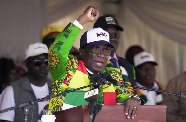 Zimbabwean President Emmerson Mnangagwa greets party supporters at a campaign rally in Harare, Wednesday, Aug. 9, 2023. Mnangagwa addressed thousands of supporters in a speech laden with calls for peace, days after his supporters were accused of stoning an opposition activist to death ahead of general elections set for Aug. 23. (AP Photo/Tsvangirayi Mukwazhi)