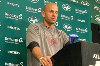 New York Jets coach Robert Saleh, wearing a T-shirt in support of Dwight Morrow High School in Englewood, N.J., which was hit hard by Hurricane Ida, speaks to reporters at the team's NFL football facility in Florham Park, N.J., on Friday, Sept. 17, 2021. (AP Photo/Dennis Waszak Jr.)