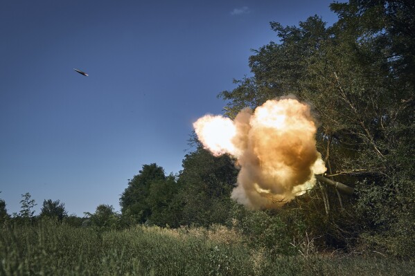 Ukrainian soldiers fire a self-propelled howitzer towards Russian positions at the front line in Donetsk region, Ukraine, Wednesday, Aug. 9, 2023. (AP Photo/Libkos)