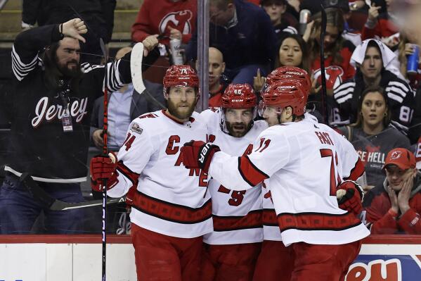 Carolina Hurricanes left wing Jordan Martinook (48) is congratulated by teammates after scoring a goal against the New Jersey Devils during the second period of Game 4 of an NHL hockey Stanley Cup second-round playoff series Tuesday, May 9, 2023, in Newark, N.J. (AP Photo/Adam Hunger)
