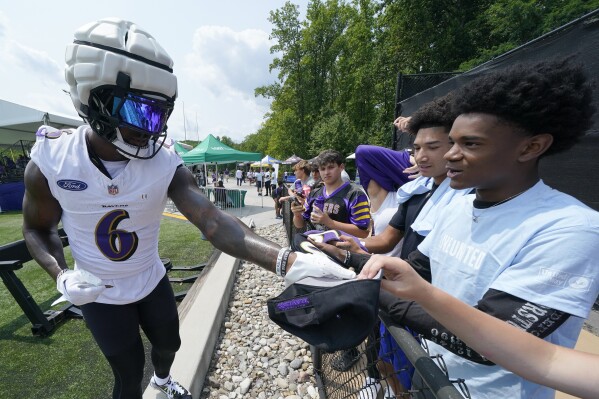 Baltimore Ravens linebacker Patrick Queen signs autographs during his team's NFL football training camp, Wednesday, Aug. 2, 2023, in Owings Mills, Md. (AP Photo/Julio Cortez)