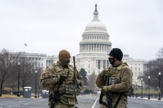 Members of the National Guard patrol the area outside of the U.S. Capitol on the third day of the second impeachment trial of former President Donald Trump, on Capitol Hill in Washington, Thursday, Feb. 11, 2021. (AP Photo/Jose Luis Magana)