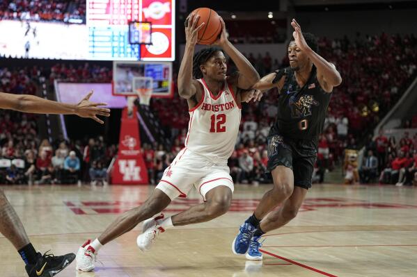 Houston guard Tramon Mark (12) drives around Memphis guard Elijah McCadden (0) during the second half of an NCAA college basketball game, Sunday, Feb. 19, 2023, in Houston. (AP Photo/Kevin M. Cox)