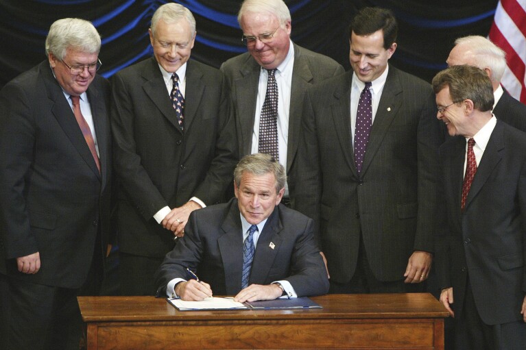 FILE - President George W. Bush signs legislation banning so-called partial-birth abortions, Nov. 5, 2003, in Washington, as from left, House Speaker Dennis Hastert of Ill., Sen. Orrin Hatch, R-Utah, Rep. James Sensenbrenner, R-Wis., Sen. Rick Santorum, R-Pa., Rep. James Oberstar, D-Minn., obscured, and Sen. Mike DeWine, R-Ohio, watch. As campaigning escalates in Ohio's fall fight over abortion rights, a new line of attack from opponents suggests "partial-birth" abortions would be revived if a proposed constitutional amendment passes. But the procedure has been banned nationwide for over 15 years. (AP Photo/Ron Edmonds, File)