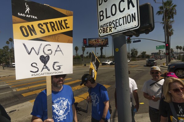 SAG-AFTRA actors walk on a picket line outside Netflix studios on Tuesday, Sep. 26, 2023, in Los Angeles. (AP Photo/Damian Dovarganes)