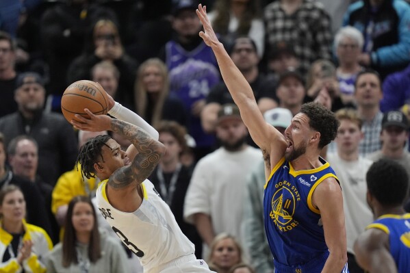 Golden State Warriors guard Klay Thompson (11) defends against Utah Jazz guard Keyonte George, left, during the second half of an NBA basketball game Thursday, Feb. 15, 2024, in Salt Lake City. (AP Photo/Rick Bowmer)