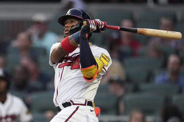 Atlanta Braves' Ronald Acuna Jr. watches his solo home run in the first inning of a baseball game against the Philadelphia Phillies Tuesday, Sept. 19, 2023. (AP Photo/John Bazemore)