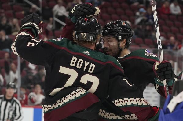 Arizona Coyotes' Nick Schmaltz (8) right, celebrates with Travis Boyd (72) after Boyd's goal against the Montreal Canadiens during the first period of an NHL hockey game Monday, Jan. 17, 2022, in Glendale, Ariz. (AP Photo/Darryl Webb)