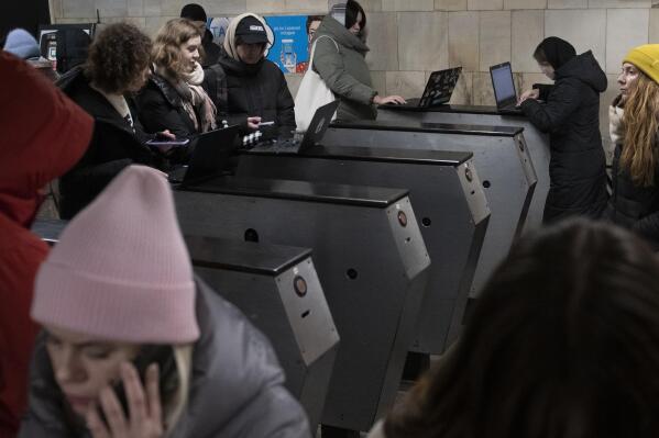 People work in the subway station being used as a bomb shelter during a rocket attack in Kyiv, Ukraine, Monday, Dec. 5, 2022. Ukraine’s air force said it shot down more than 60 of about 70 missiles that Russia fired on in its latest barrage against Ukraine. It was the latest onslaught as part of Moscow’s new, stepped-up campaign that has largely targeted Ukrainian infrastructure and disrupted supplies of power, water and heat in the country as winter looms. (AP Photo/Andrew Kravchenko)