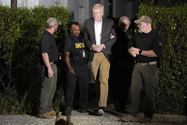 FILE - Alex Murdaugh , center, is led out of Colleton County Courthouse by sheriff's deputies after being convicted March 2, 2023, in Walterboro, S.C. Former South Carolina Supreme Court Justice Jean Toal plans to hold an evidentiary hearing late January 2024, in Murdaugh's appeal for a new murder trial. (AP Photo/Chris Carlson, File)