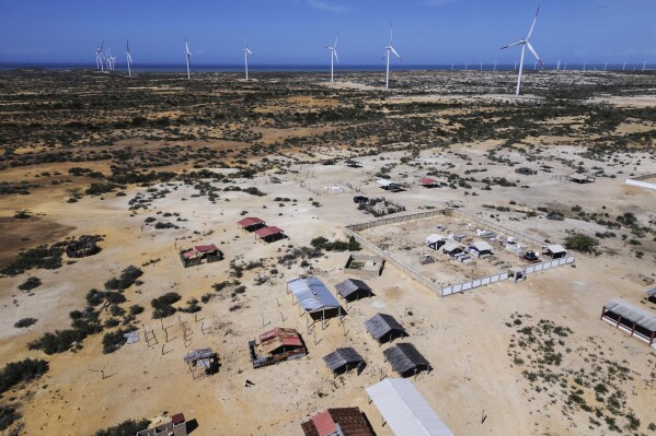 Wind turbines operate near a Wayuu Indigenous cemetery on the outskirts of Cabo de la Vela, Colombia, Feb. 7, 2025. (AP Photo/Ivan Valencia, File)