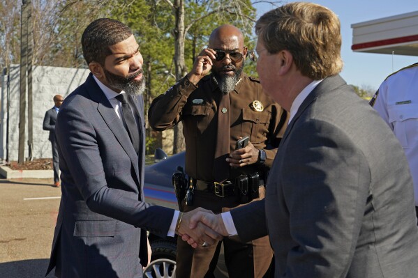 Jackson, Miss., Mayor Chokwe Antar Lumumba, left, and Mississippi Republican Gov. Tate Reeves, right, shake hands after the governor announced a major public safety operation called Operation Unified for the city of Jackson, involving coordinated efforts between state, local, and federal law enforcement agencies to get drug traffickers and violent criminals off the capital city's streets, Tuesday, Feb. 13, 2024, in Jackson, Miss. (AP Photo/Rogelio V. Solis)