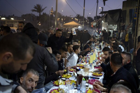 Muslims break their fast with the Iftar meal after the last Friday prayers of the Muslim holy month of Ramadan, outside the Old City of Jerusalem, April 5, 2024. (AP Photo/Leo Correa)