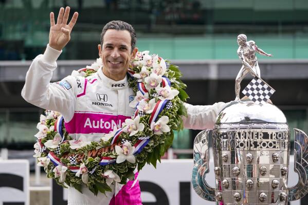 FILE - Helio Castroneves of Brazil, winner of the 2021 Indianapolis 500 auto race, poses during the traditional winners photo session at the Indianapolis Motor Speedway in Indianapolis, in this Monday, May 31, 2021, file photo. Helio Castroneves will race for a record fifth Indianapolis 500 in 2022 with Meyer Shank Racing. Castroneves, who won his tying fourth Indy 500 in May, has agreed to a full season ride with Meyer Shank. (AP Photo/Michael Conroy, File)