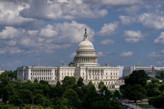 FILE - In this June 20, 2019, file photo, the Capitol is seen from the roof of the Canadian Embassy in Washington. America’s much-maligned health care system is covering more people than ever, a fact lost on many of the 2020 presidential candidates, who keep debating polarizing ideas about how to set up coverage, from Sen. Bernie Sanders’ call for replacing private insurance with a government plan, to President Donald Trump’s determination to erase “Obamacare.” (AP Photo/J. Scott Applewhite, File)