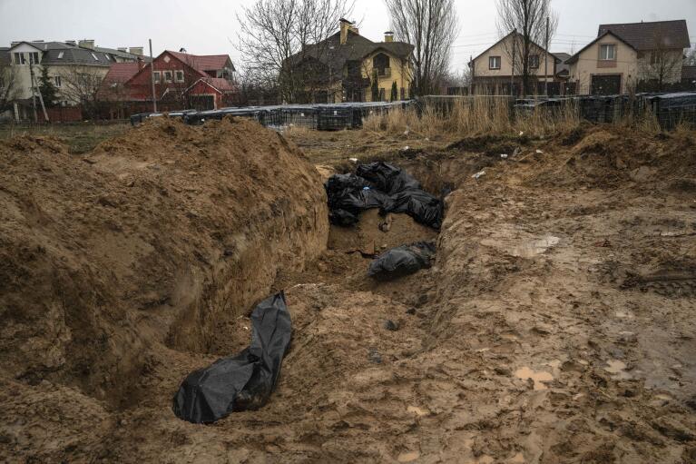 FILE - Bodies lie scattered in a mass grave in Bucha, Ukraine, on the outskirts of Kyiv, Sunday, April 3, 2022. Ukrainian troops found brutalized bodies and widespread destruction in the suburbs of Kyiv. (AP Photo/Rodrigo Abd, File)