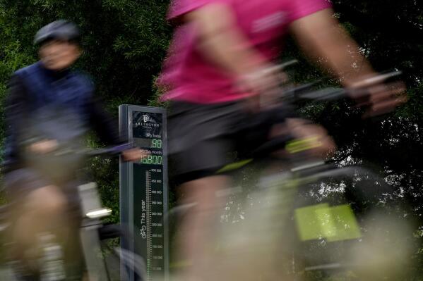 Cyclists are counted as they ride past the Rosslyn Bikeometer on National Bike to Work Day in Arlington, Va., Friday, May 19, 2023. The Bikeometer monitors the volume of bike usage on the Custis Trail in Arlington, Va. A Rutgers-Virginia Tech study of cycling in more than a dozen cities in North America and Europe finds that many new bikeways were built during the height of COVID-19. And these efforts were rewarded with increased cycling in places that undertook robust development. (AP Photo/Carolyn Kaster)