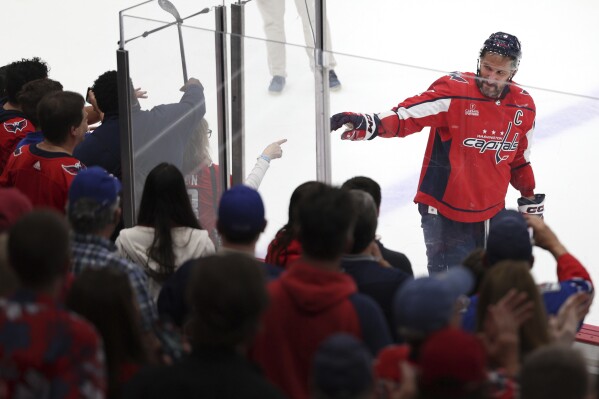 Washington Capitals left wing Alex Ovechkin (8) points to a fan after being eliminated by the New York Rangers in Game 4 of an NHL hockey Stanley Cup first-round playoff series Sunday, April 28, 2024, in Washington. (AP Photo/Tom Brenner)
