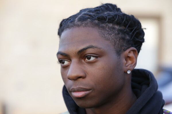 Darryl George, a 17-year-old junior, before walking across the street to go into Barbers Hill High School after serving a 5-day in-school suspension for not cutting his hair Monday, Sept. 18, 2023, in Mont Belvieu. (AP Photo/Michael Wyke)