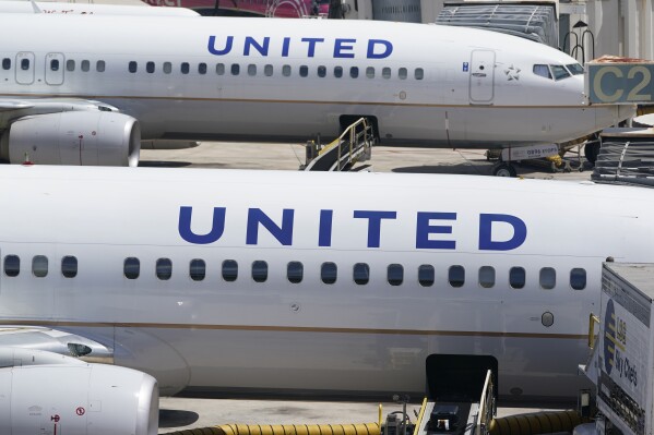 FILE - Two United Airlines Boeing 737s are parked at the gate at the Fort Lauderdale-Hollywood International Airport in Fort Lauderdale, Fla., July 7, 2022. United Airlines said Wednesday, Feb. 21, 2024, that it plans to resume flights to Israel in March, reviving a route that was suspended in October 2023 at the start of the Israel-Hamas war. (AP Photo/Wilfredo Lee, File)