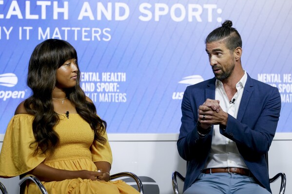 Michael Phelps, right, speaks during a forum on mental health with Naomi Osaka, during the U.S. Open tennis championships, Wednesday, Sept. 6, 2023, in New York. (AP Photo/Mary Altaffer)