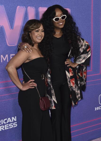 H.E.R., right, and mother Agnes Wilson arrive at the Billboard Women in Music Awards on Wednesday, March 2, 2022, at the YouTube Theater in Los Angeles. (Photo by Jordan Strauss/Invision/AP)