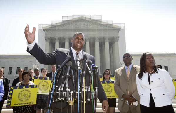 Ryan P. Haygood, director of the NAACP Legal Defense Fund, talks outside the Supreme Court in Washington, Tuesday, June 25, 2013, about the Shelby County v. Holder, a voting rights case in Alabama. Charles White, the national field director for the NAACP is second from right and Sherrilyn Ifill, president of the NAACP Legal Defense Fund is at right. The Supreme Court says a key provision of the landmark Voting Rights Act cannot be enforced until Congress comes up with a new way of determining which states and localities require close federal monitoring of elections. (AP Photo/J. Scott Applewhite)