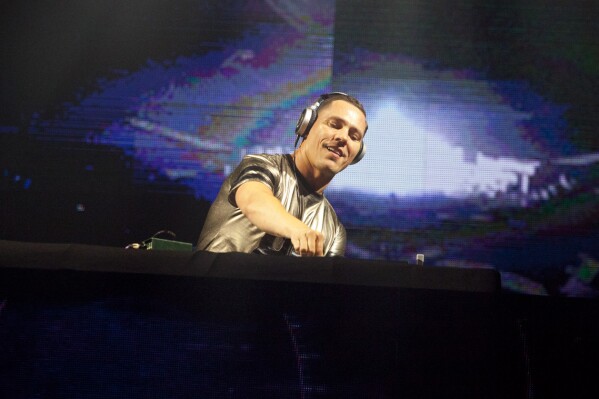 FILE - DJ Tiesto performs during a concert at the Presidente Festival at the Olympic Stadium in Santo Domingo, Dominican Republic on Oct. 3, 2014. Dutch music producer DJ Tiësto has withdrawn from performing at Sunday's Super Bowl due to an undisclosed family matter. The Dutchman wrote on social media that “it was a tough decision to miss the game, but family always comes first.” (AP Photo/Tatiana Fernandez, File)