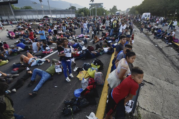 Migrants block the highway during their caravan through Huixtla, Mexico, Wednesday, Nov. 8, 2023. About 3,000 migrants, mostly from Central America, are protesting for the government to issue them temporary documents allowing them to continue north to the U.S. border. (APPhoto/Edgar Clemente)