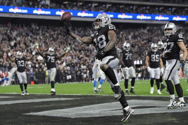 Las Vegas Raiders running back Josh Jacobs (28) celebrates after scoring a touchdown against the Los Angeles Chargers during the first half of an NFL football game, Sunday, Jan. 9, 2022, in Las Vegas. (AP Photo/David Becker)