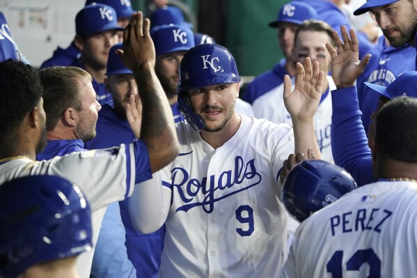 Kansas City Royals' Vinnie Pasquantino (9) is congratulated after he scored in the third inning of the team's baseball against the Houston Astros, Wednesday, April 10, 2024, in Kansas City, Mo. (AP Photo/Ed Zurga)