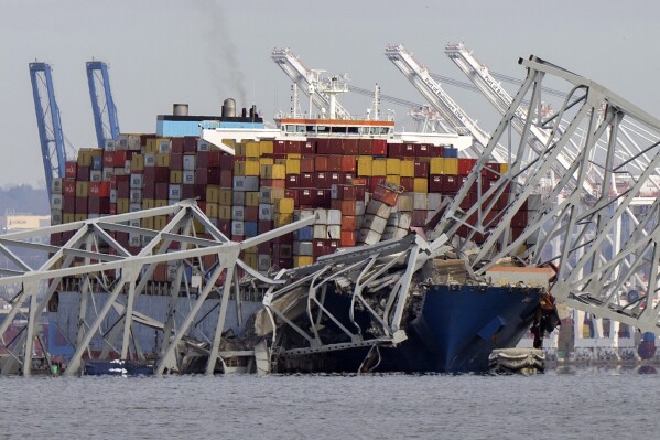 FILE - The cargo ship Dali is stuck under part of the structure of the Francis Scott Key Bridge after the ship hit the bridge, Tuesday, March 26, 2024, as seen from Pasadena, Md. Julio Cervantes Suarez, the only person who survived falling from Maryland's Francis Scott Key Bridge during its catastrophic collapse says he watched in horror as his coworkers, friends and relatives plunged to their deaths. In an exclusive interview with NBC News that aired Wednesday evening, July 10, 2024, he described fighting for his life after his truck tumbled into the Patapsco River. (ĢӰԺ Photo/Mark Schiefelbein, File)