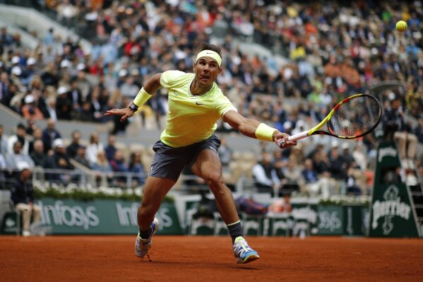 Spain's Rafael Nadal plays a shot against Switzerland's Roger Federer during their semifinal match of the French Open tennis tournament at the Roland Garros stadium in Paris, Friday, June 7, 2019. (AP Photo/Christophe Ena)